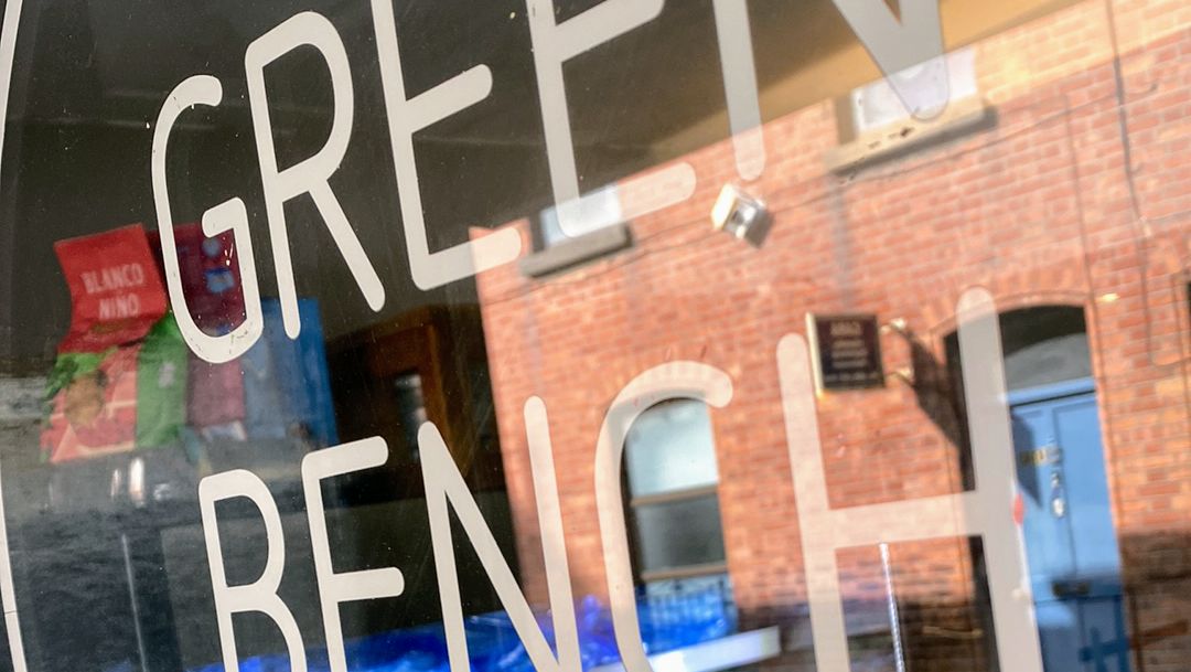 Close-up of the Green Bench Cafe shopfront window, lettered in bold white capitals